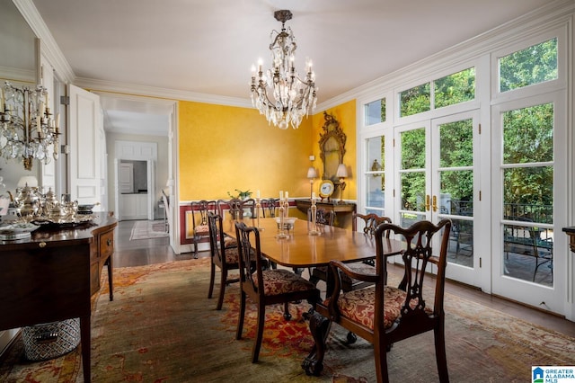 dining area featuring ornamental molding, dark wood-type flooring, a wealth of natural light, and an inviting chandelier