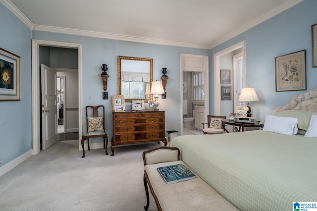 carpeted bedroom featuring ensuite bath and crown molding