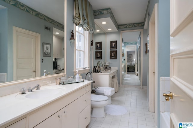 bathroom with tile patterned flooring, vanity, toilet, and a bidet