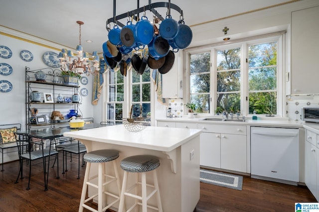 kitchen featuring a center island, white dishwasher, sink, dark hardwood / wood-style floors, and white cabinetry