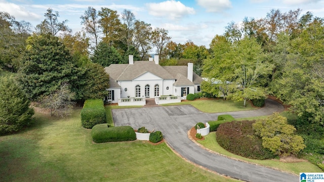 back of house with a lawn