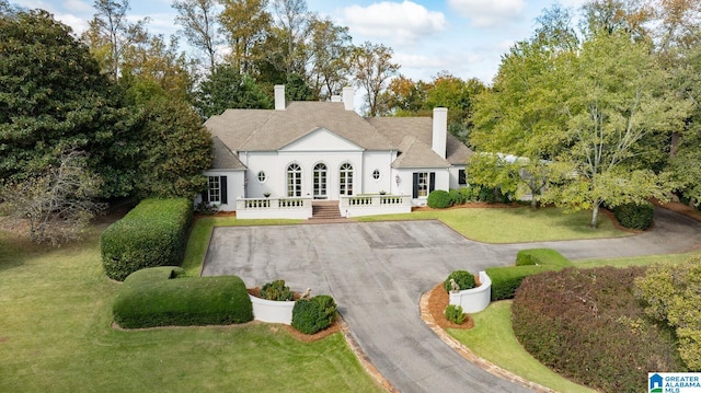 rear view of property with a lawn