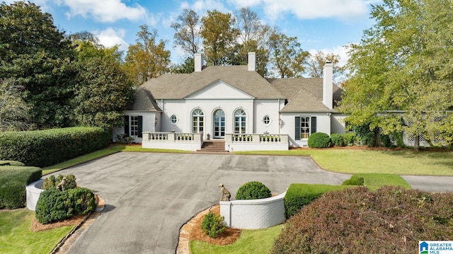 rear view of house featuring a yard