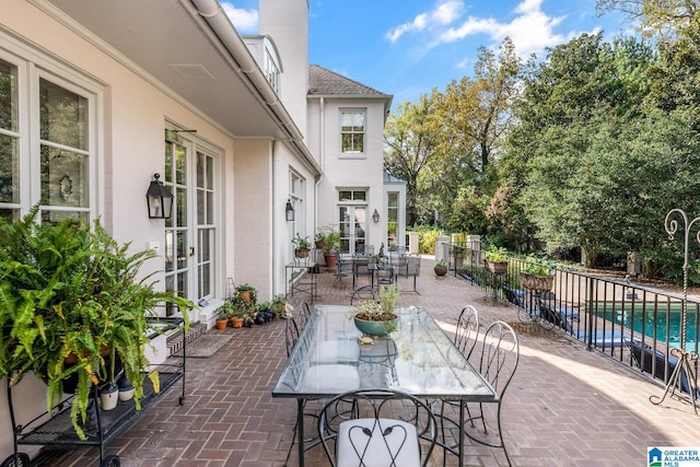 view of patio / terrace with a fenced in pool