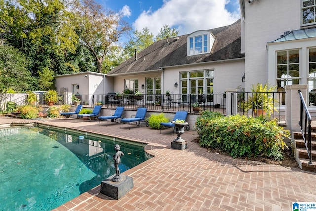 view of swimming pool with a patio area