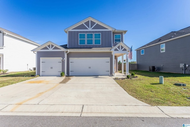 view of front facade with cooling unit, a garage, and a front yard