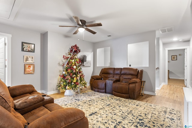 living room with ceiling fan and light hardwood / wood-style floors