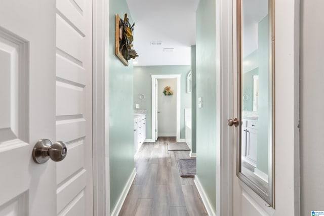 corridor with wood-type flooring