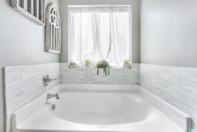 bathroom featuring a washtub and a healthy amount of sunlight