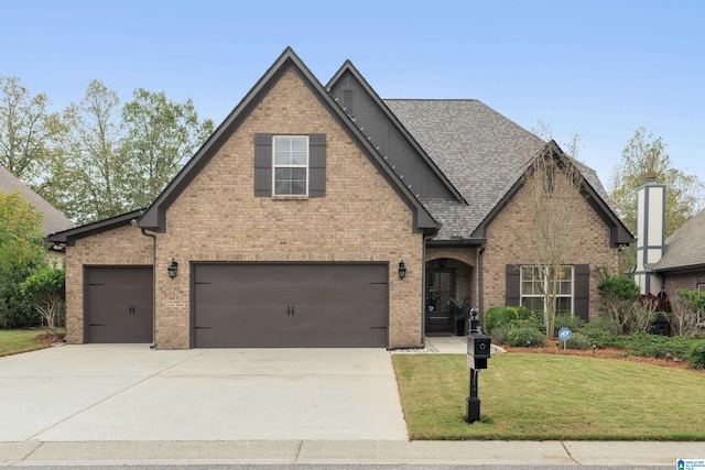 view of front of house with a garage and a front lawn