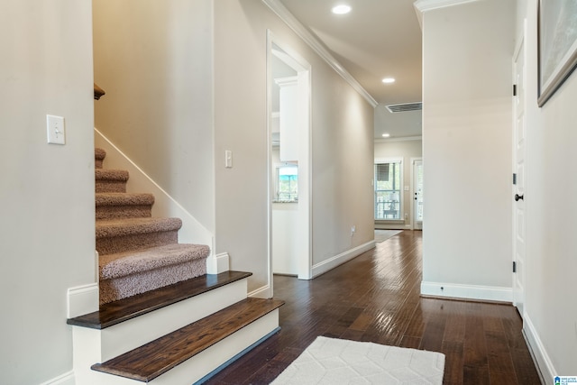 foyer entrance featuring dark hardwood / wood-style floors and crown molding