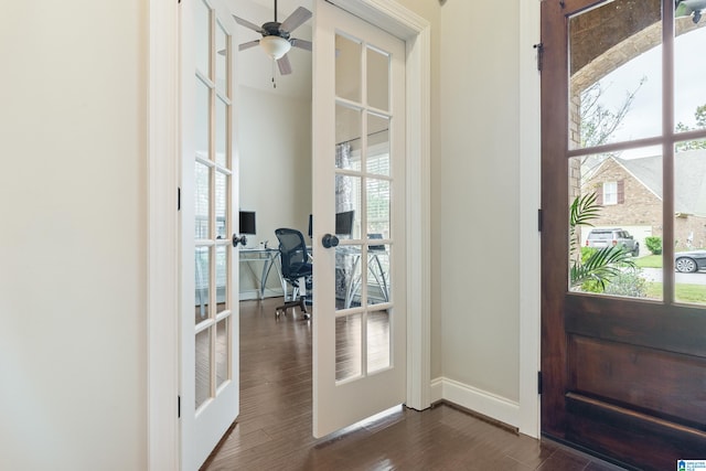 foyer with a wealth of natural light, dark hardwood / wood-style flooring, and french doors