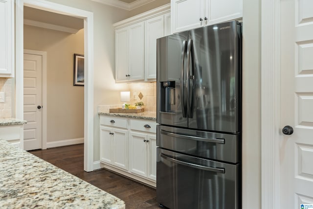 kitchen featuring decorative backsplash, stainless steel fridge with ice dispenser, white cabinetry, and light stone counters