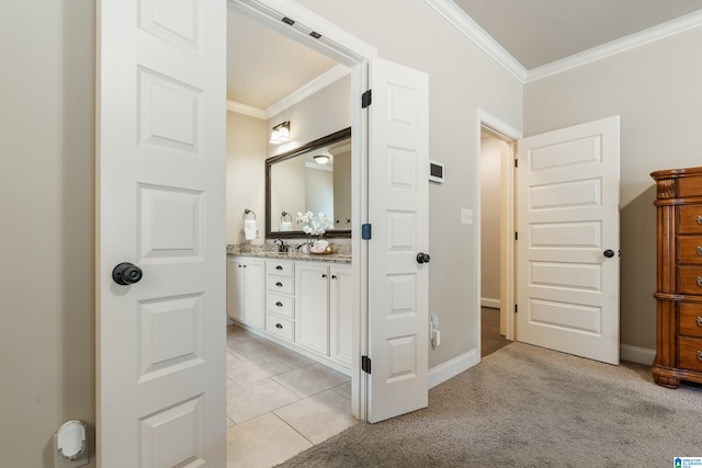 bathroom featuring tile patterned flooring, vanity, and ornamental molding