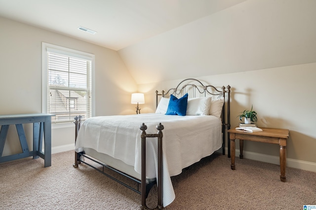 bedroom featuring carpet flooring and lofted ceiling