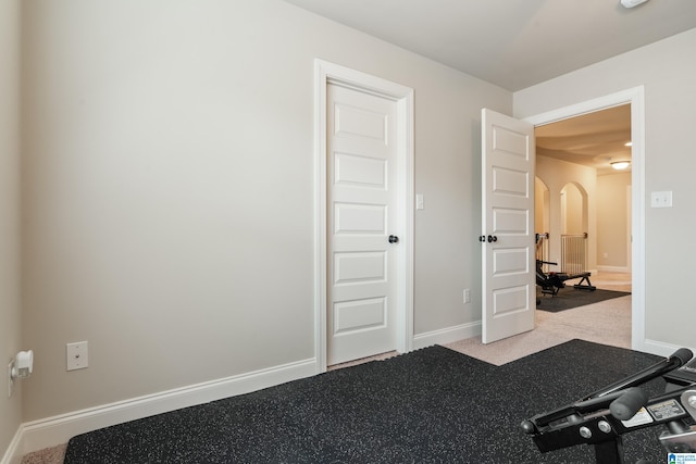 exercise area featuring light carpet