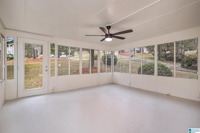 unfurnished sunroom with ceiling fan and a wealth of natural light