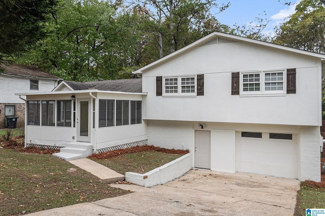 tri-level home with a garage and a sunroom