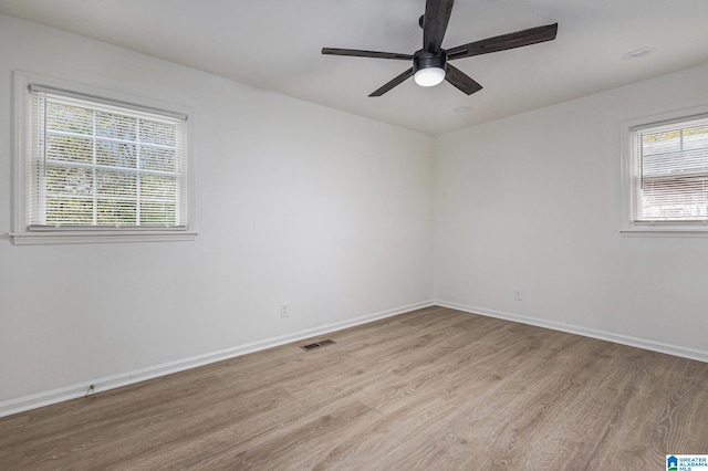 spare room with light wood-type flooring and ceiling fan