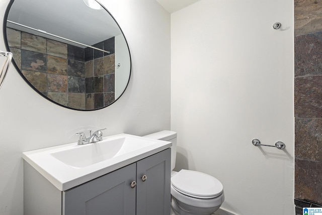 bathroom featuring vanity and toilet