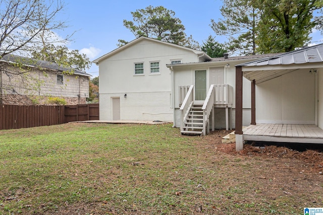 back of property featuring a lawn