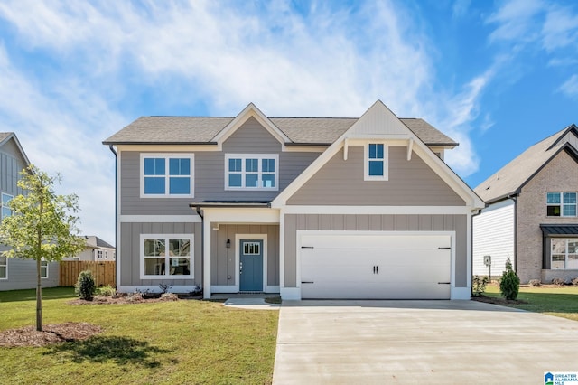 view of front of property with a front yard and a garage