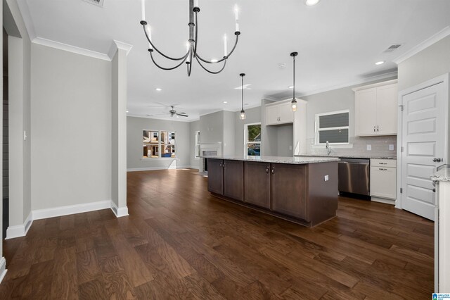 kitchen featuring pendant lighting, a center island, white cabinets, stainless steel dishwasher, and dark hardwood / wood-style flooring