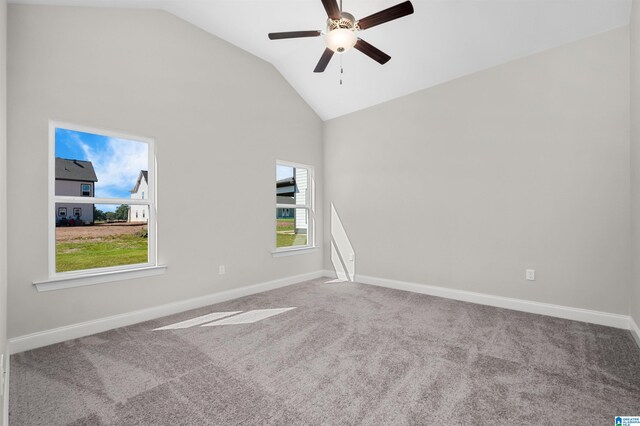 carpeted spare room featuring ceiling fan and lofted ceiling