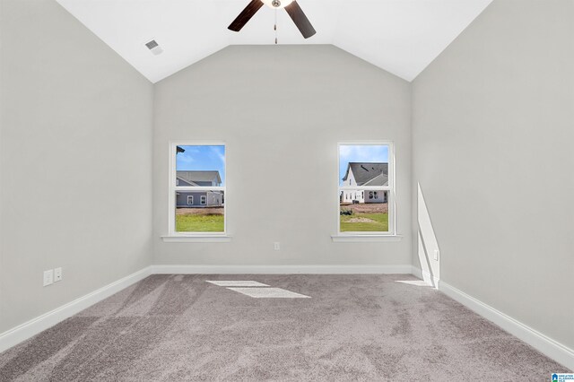 carpeted empty room with high vaulted ceiling and ceiling fan