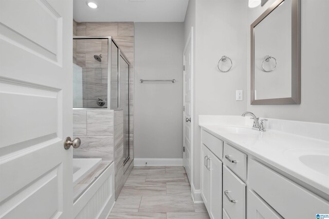 bathroom featuring vanity and separate shower and tub