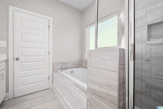 bathroom featuring vanity and separate shower and tub