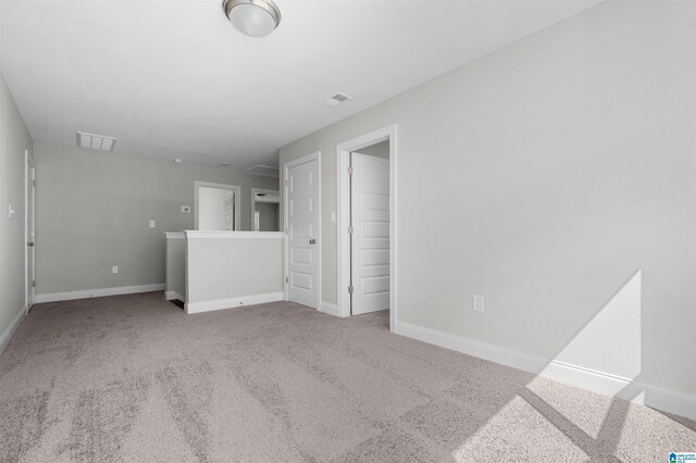 empty room featuring light colored carpet