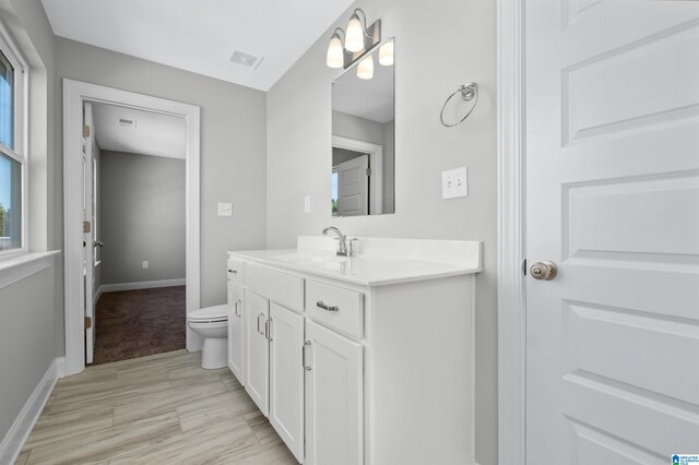 bathroom featuring vanity and toilet