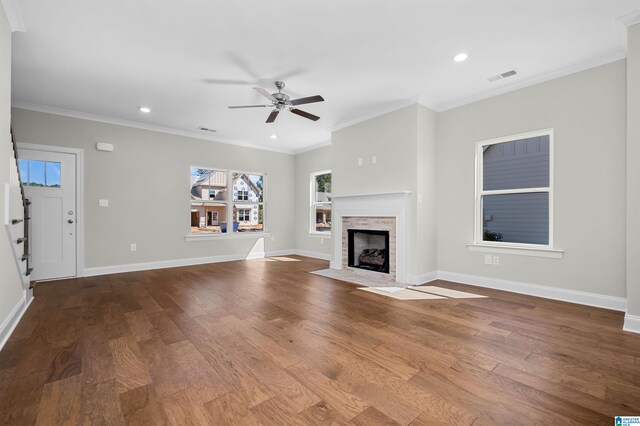 unfurnished living room featuring ceiling fan, ornamental molding, and hardwood / wood-style flooring