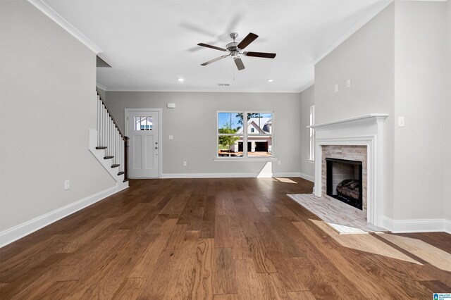 unfurnished living room featuring ceiling fan, wood-type flooring, and ornamental molding