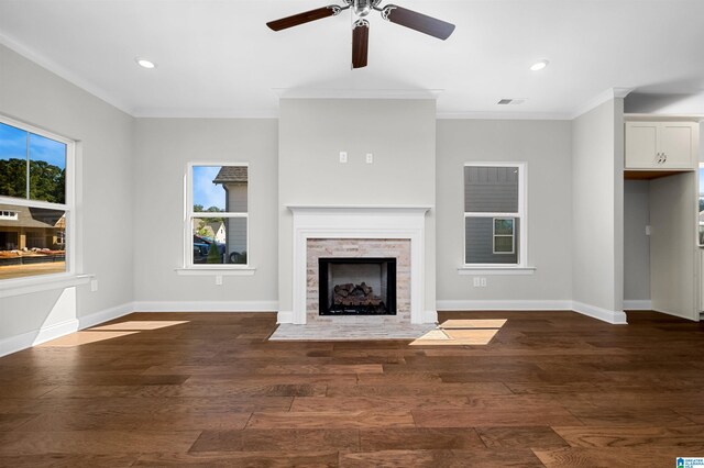 unfurnished living room with crown molding, dark hardwood / wood-style flooring, and ceiling fan