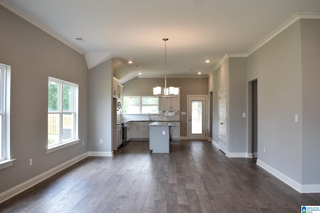 kitchen with sink, a notable chandelier, a center island, dark hardwood / wood-style floors, and hanging light fixtures