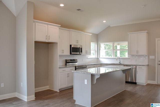 kitchen with white cabinets, a kitchen island, and stainless steel appliances