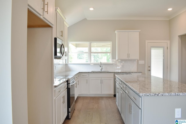 kitchen featuring backsplash, sink, white cabinets, and stainless steel appliances