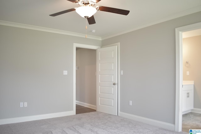 unfurnished bedroom featuring ceiling fan, carpet floors, and ornamental molding