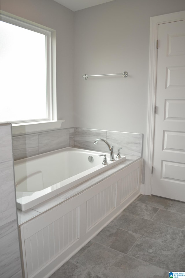 bathroom featuring a bathtub and tile patterned flooring