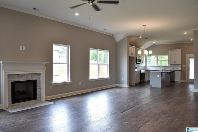 unfurnished living room featuring ornamental molding, dark hardwood / wood-style flooring, ceiling fan, and lofted ceiling