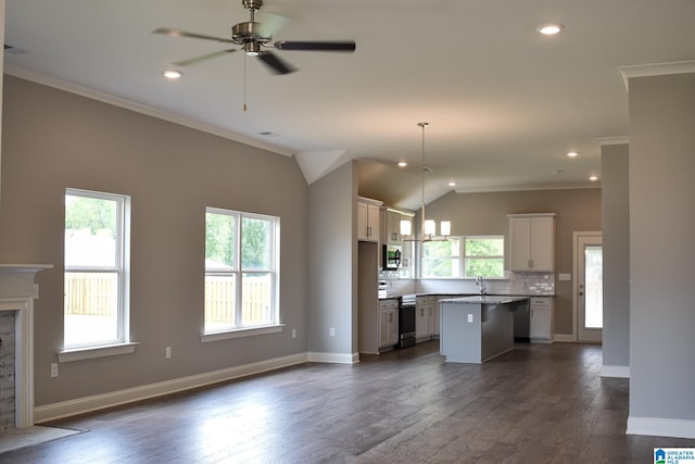 kitchen with plenty of natural light, a kitchen island, stainless steel appliances, and hanging light fixtures