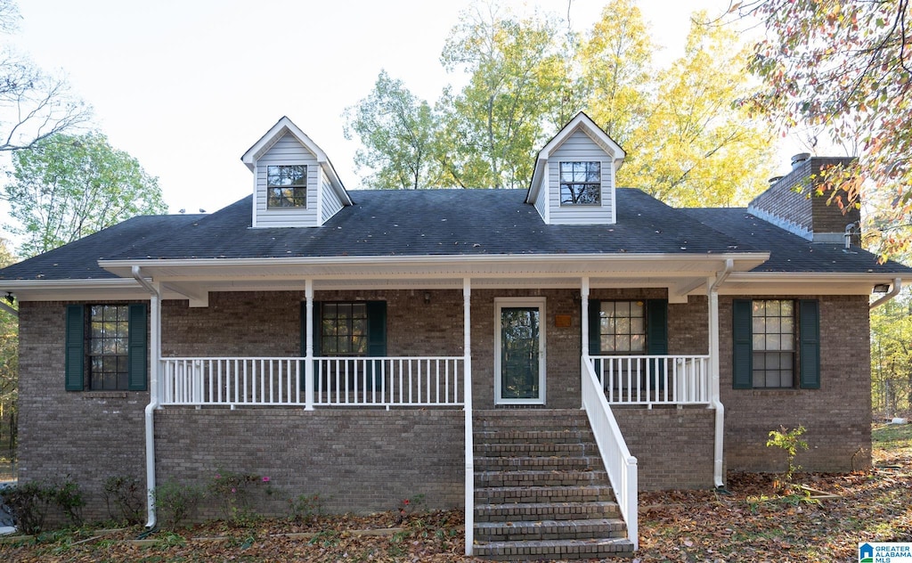 cape cod-style house with covered porch