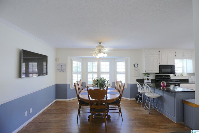 dining space featuring a textured ceiling, ceiling fan, dark hardwood / wood-style floors, and ornamental molding