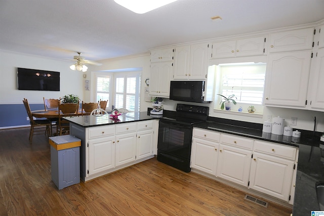 kitchen featuring kitchen peninsula, white cabinets, black appliances, and dark hardwood / wood-style floors