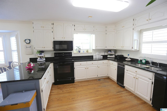 kitchen with sink, light hardwood / wood-style flooring, white cabinets, black appliances, and ornamental molding