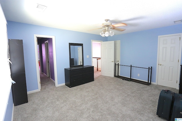 interior space featuring ceiling fan and light colored carpet