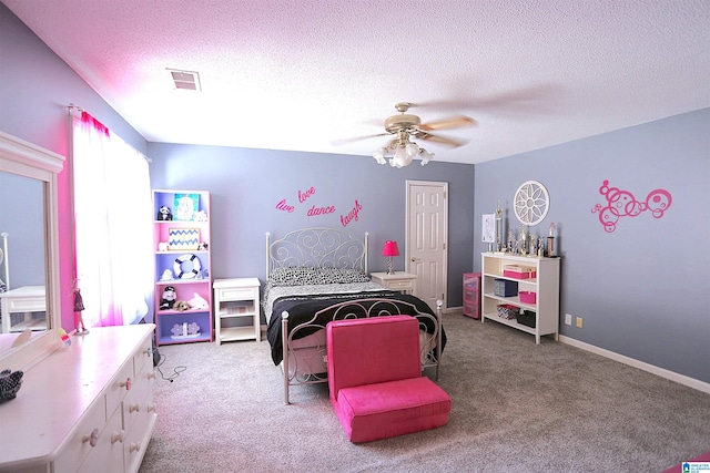 bedroom with ceiling fan, light carpet, and a textured ceiling