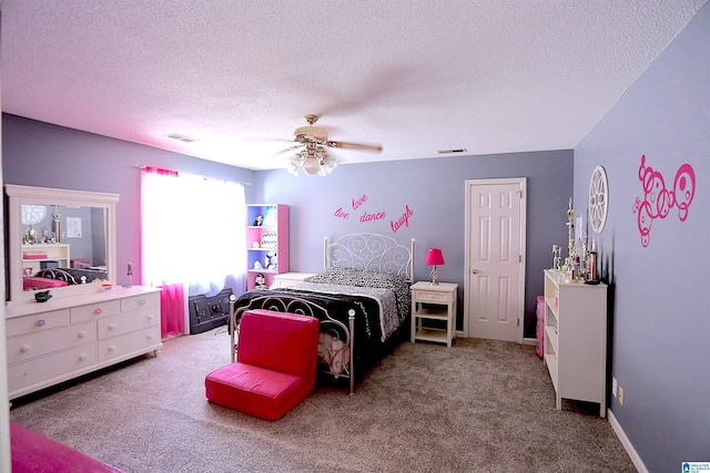 carpeted bedroom featuring a textured ceiling and ceiling fan